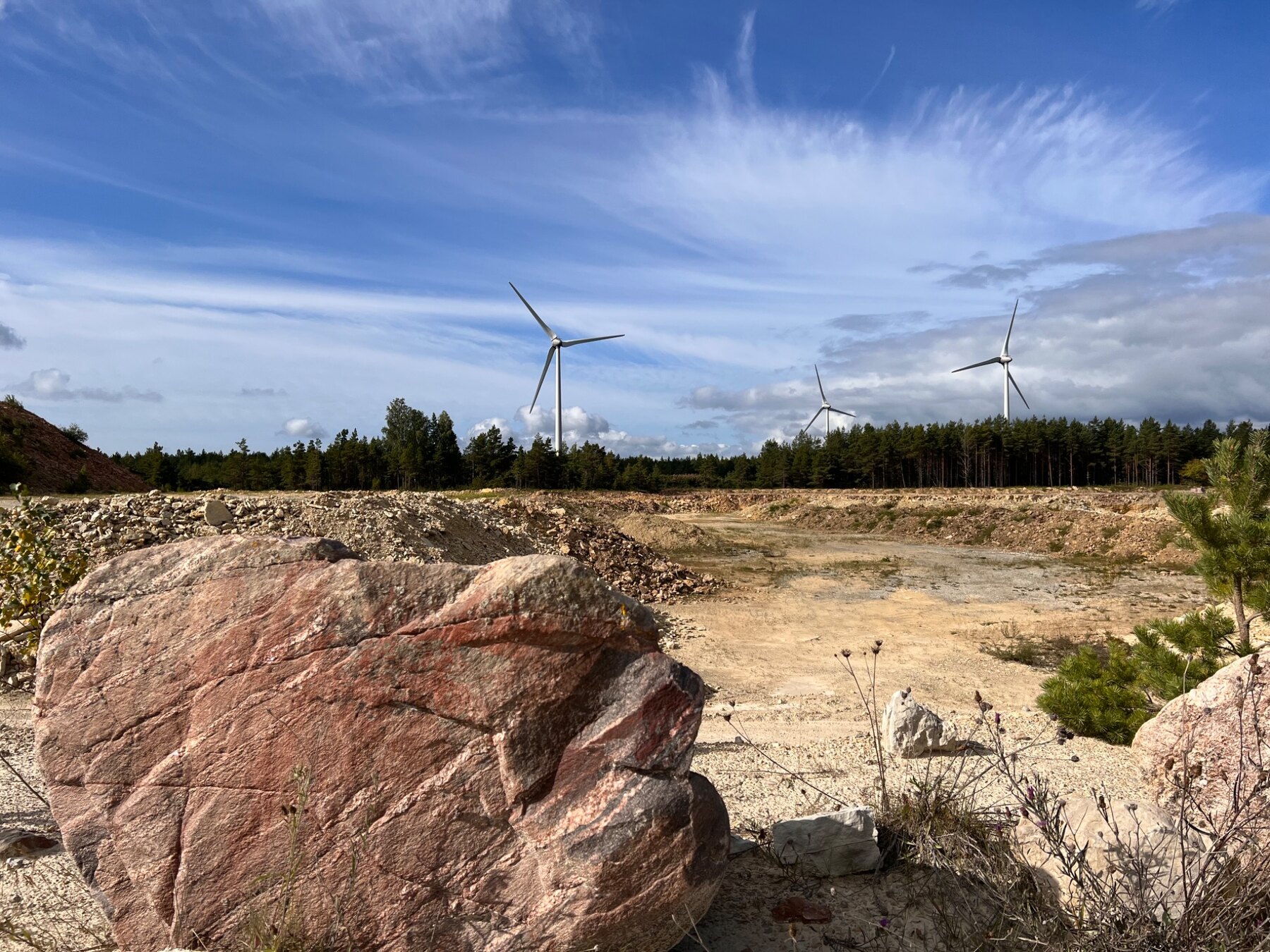 Kurevere quarry in Estonia with wind turbines beyond the site